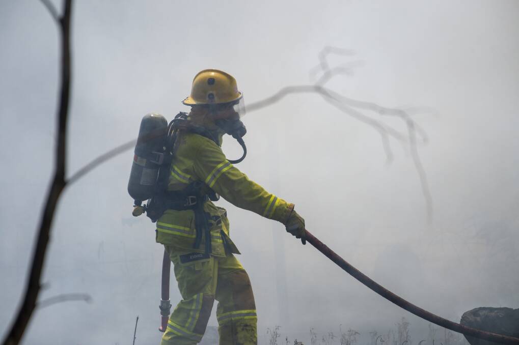 A firefighter patrols a blaze in 2019. Picture: GLENN DANIELS