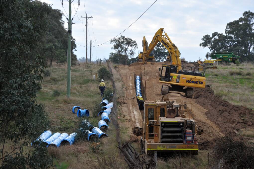 A construction crew lays pipe for a Coliban Water project. Picture by Brendan McCarthy