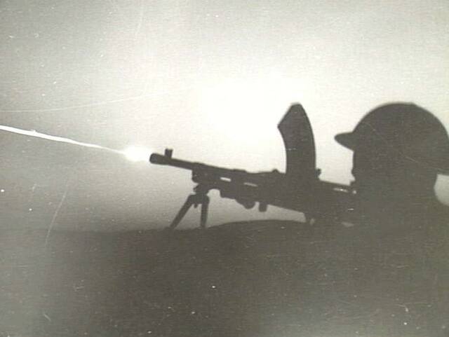 An Australian soldier fires tracer bullets from a Bren gun at German positions in August, 1941 during the siege of Tobruk. Picture: GEORGE SILK courtesy of the AUSTRALIAN WAR MEMORIAL
