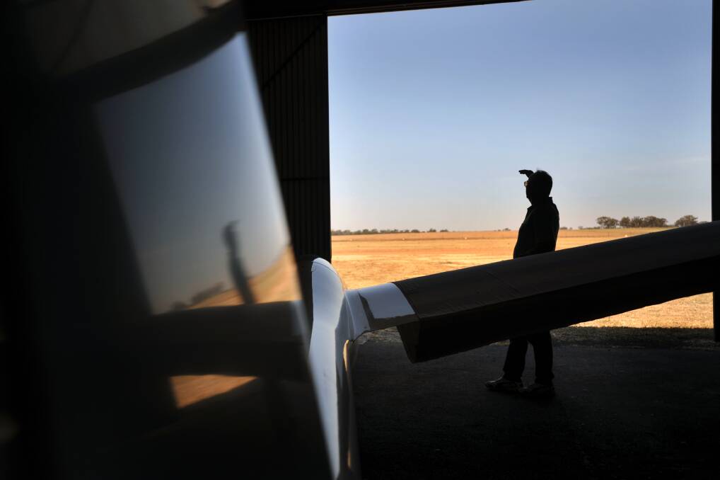 A glider pilot watch an aircraft preparing to land. Picture: NICK McGRATH