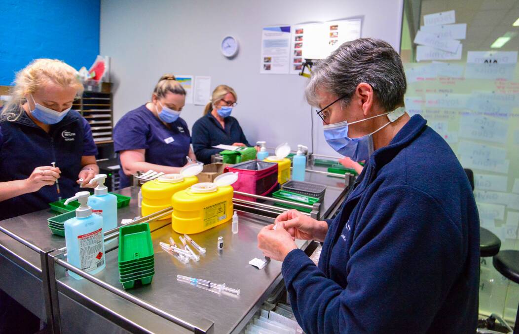 Bendigo healthcare workers prepare vaccination doses in Bendigo in what authorities say is the only way to bring the pandemic to a close. Picture: DARREN HOWE