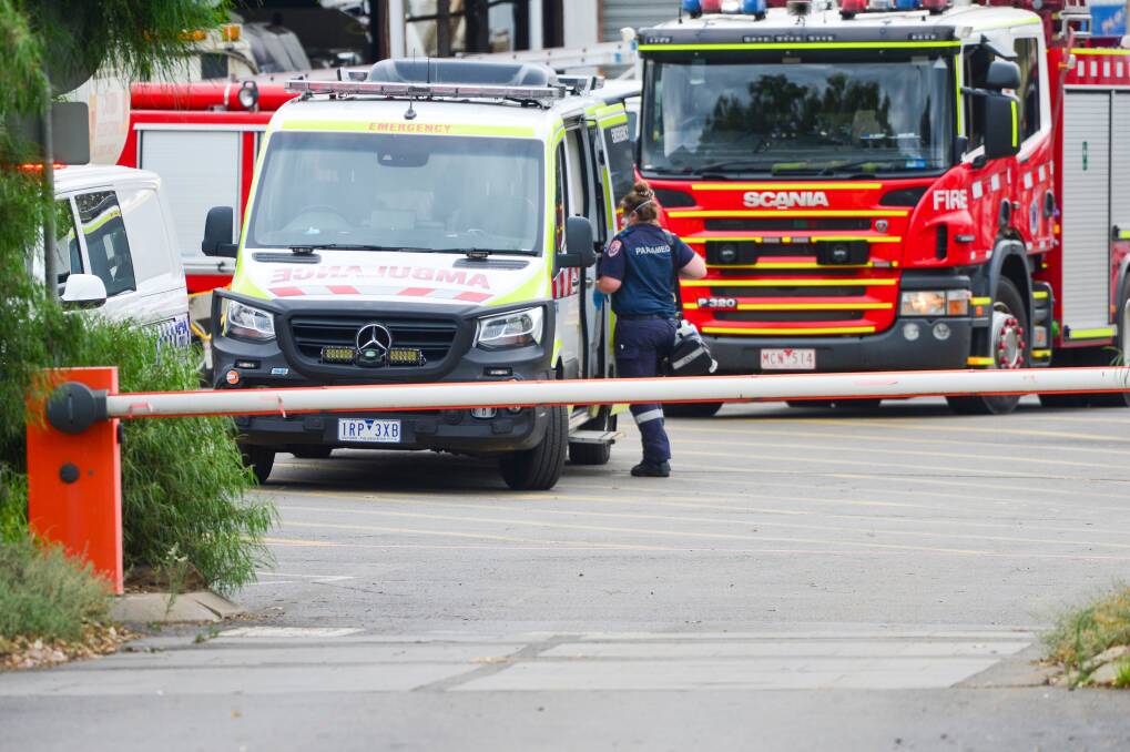 A paramedic at the scene of an explosion at a depot in Adam Street on Monday afternoon. Picture: DARREN HOWE