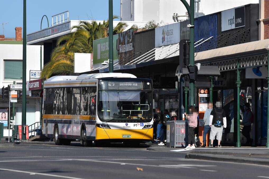 TALKS WELCOMED: Crowds stand on footpaths outside Mitchell Street shops at bus stops a lobby group says is "not ideal". Picture: NONI HYETT