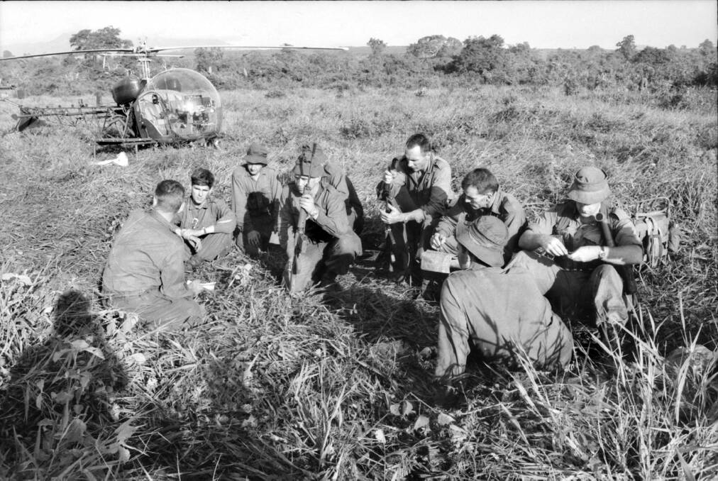 BRIEF RESPITE: Members of 6RAR's D company meet before returning to Long Tan the day after the battle in 1966. Picture: Courtesy of the Australian War Memorial