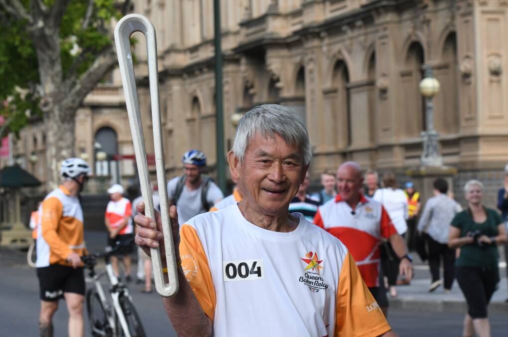 Russell Jack carries the 2018 queen's baton through Bendigo's city centre in the lead up to the Gold Coast Commonwealth Games. Picture by Noni Hyett