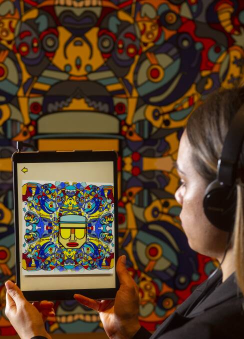 Shonae Hobson views one of the pieces through an iPad app. Picture: DARREN HOWE
