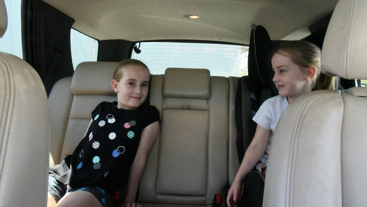 DRIVE TIME: Chloe and Mikayla Tatt take the car to school. Their mum says she would like them to walk but is concerned they are not old enough to navigate busy roads.