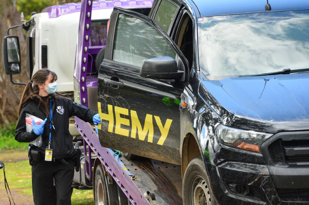 Police officers at the scene of an incident, with a car about to be towed from the scene. Picture: DARREN HOWE