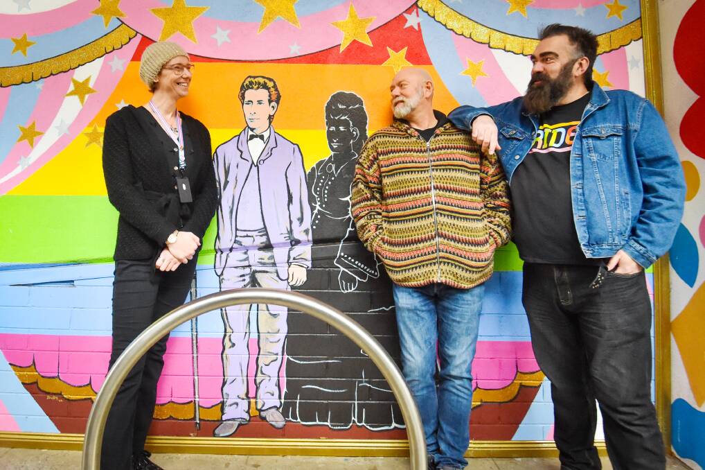Zara Jones, Chris Butler and John Richards consider the possibilities at a mural celebrating Edward de Lacy Evans. Picture by Darren Howe