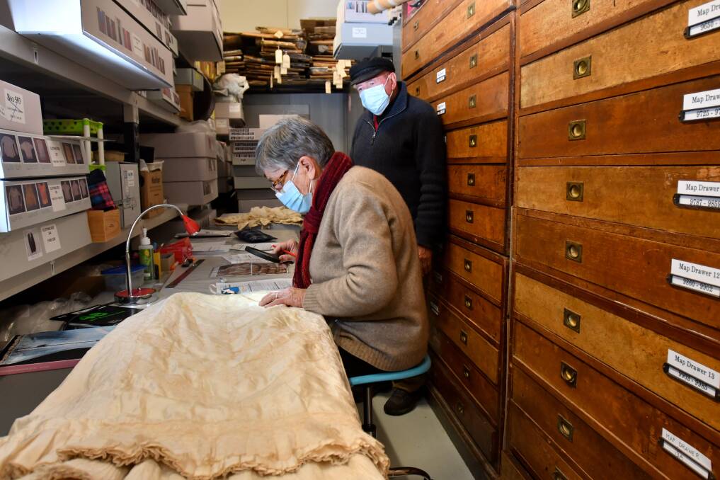 Historians Joan Hunter and Jim Evans inspect some of the pieces in the Bendigo Regional Archive Centre's collection at Nolan Street. Picture; NONI HYETT