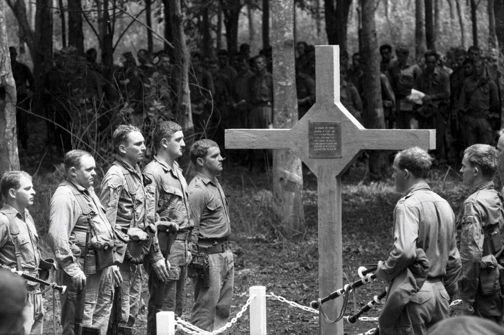 LEST WE FORGET: A Long Tan cross ceremony in Vietnam during the depths of the war. Photo: Denis Gibbons, courtesy of the Australian War Memorial