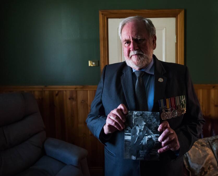 Mike Rohde with a picture from his time serving in the Australian army. Picture by Brendan McCarthy