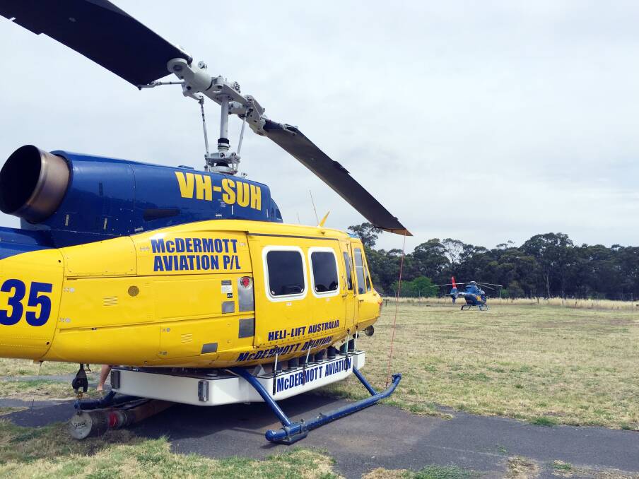 Firefighting helicopters like this one currently land on a field at the Bendigo Airport.