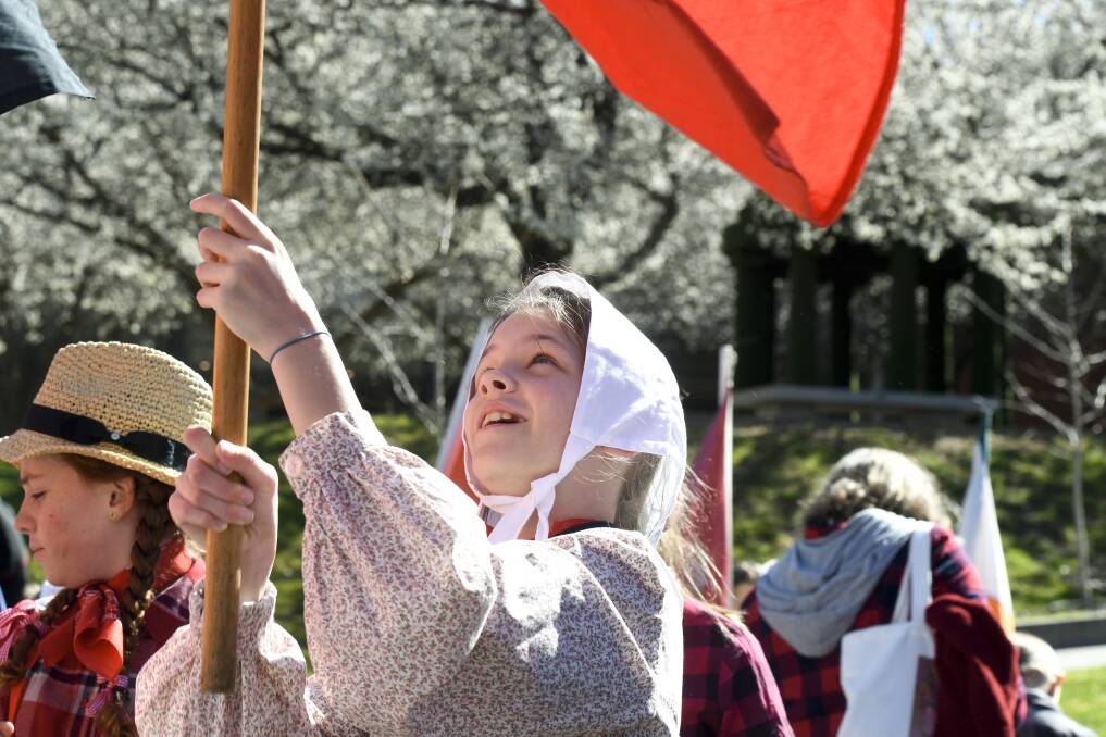 A primary school student takes part in a reenactment of a Red Ribbon Rebellion march. The annual event was cancelled in 2020 because of coronavirus.
