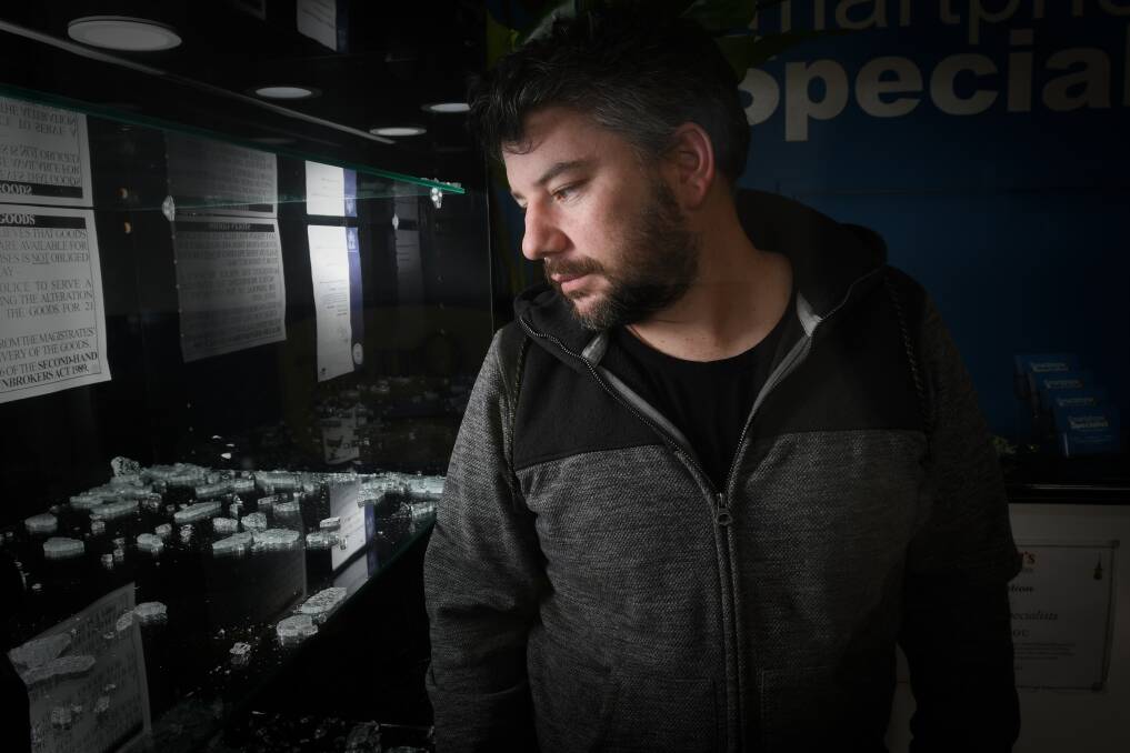 PICKING UP THE PIECES: Clint Francis surveys the damage done last night during a break-in. Picture: NONI HYETT