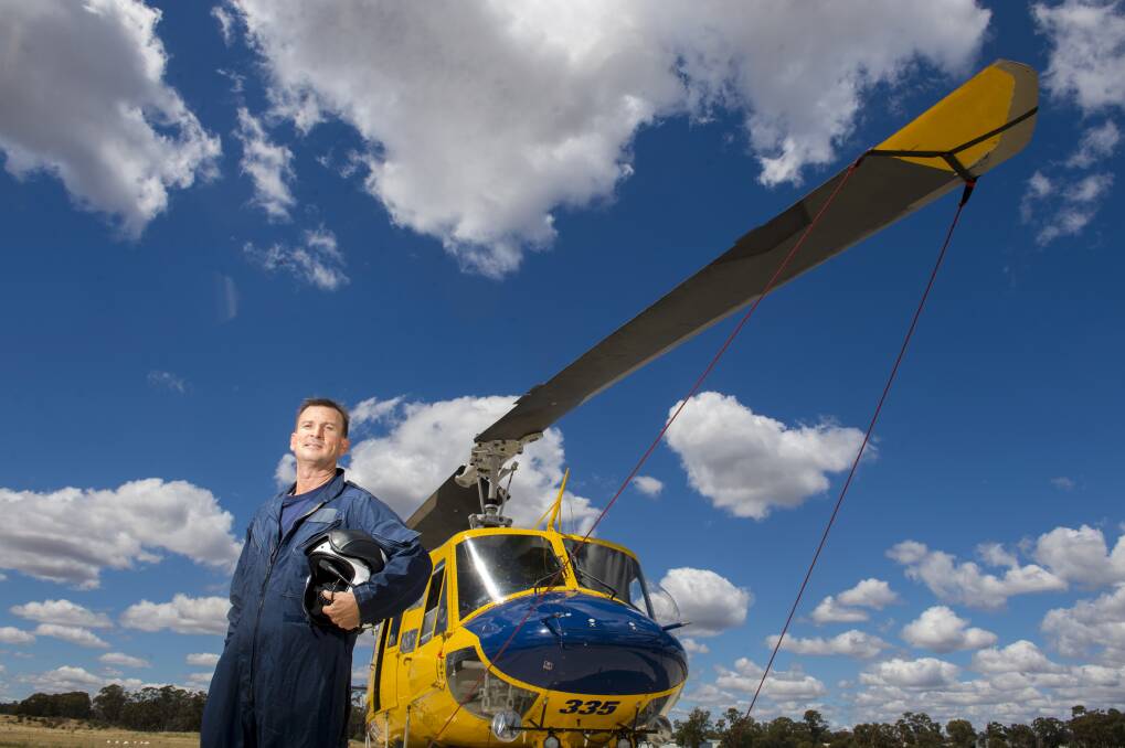 READY FOR BATTLE: Lochie Tremain-Hill will pilot this Bendigo-based water bombing helicopter over the summer fire season. Picture: DARREN HOWE
