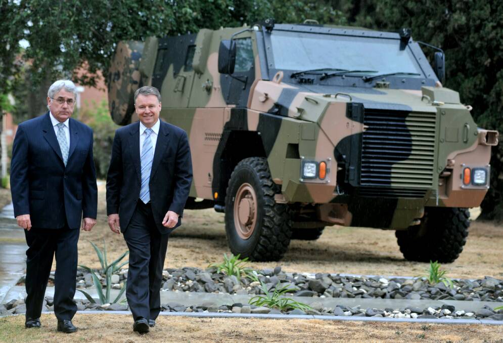 The then member for Bendigo Steve Gibbons and defence minister Joel Fitzgibbons in about 2008, roughly the period Thales began using its reputation for Bushmaster vehicles (pictured) to spruik for the Hawkei contract. Picture: ALEX ELINGHAUSEN