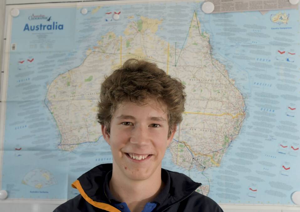 Solomon Cameron with the Australian Geographic map Bendigo pilots used to track his journey. Picture: NONI HYETT