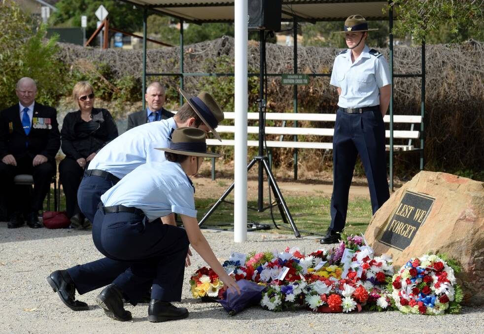 BENDIGO REMEMBERS: Airforce Cadets Brodie Hartigan and Shay Bonser lay flowers at a 2014 commemoration ceremony of the bombing of Darwin.