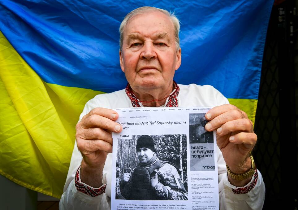 Ray Slywka with a printout of a Ukrainian newspaper article on the death of family member Sopovsky Yuri Vesilievich. Picture by Brendan McCarthy.