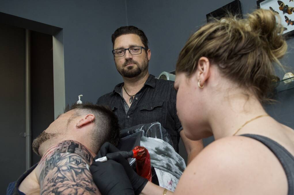 COUNTING THE COSTS: Glen Howard and Samara Belz are upgrading security after a break-in at their Chancery Lane tattoo studio. Picture: DARREN HOWE