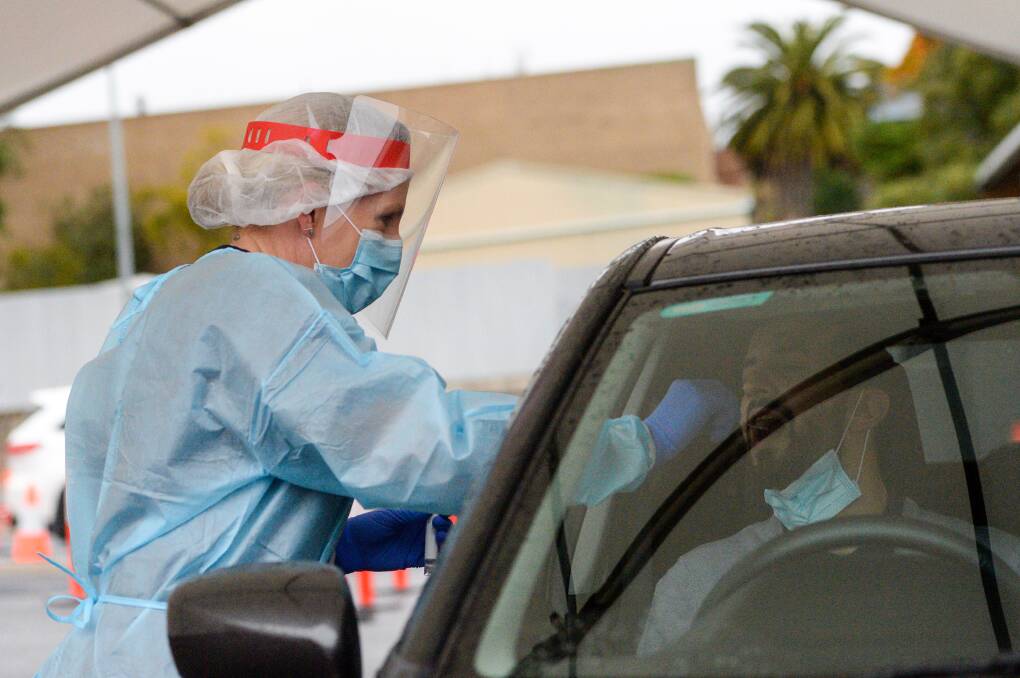 A health worker conducts a COVID-19 test in Bendigo. Picture: DARREN HOWE