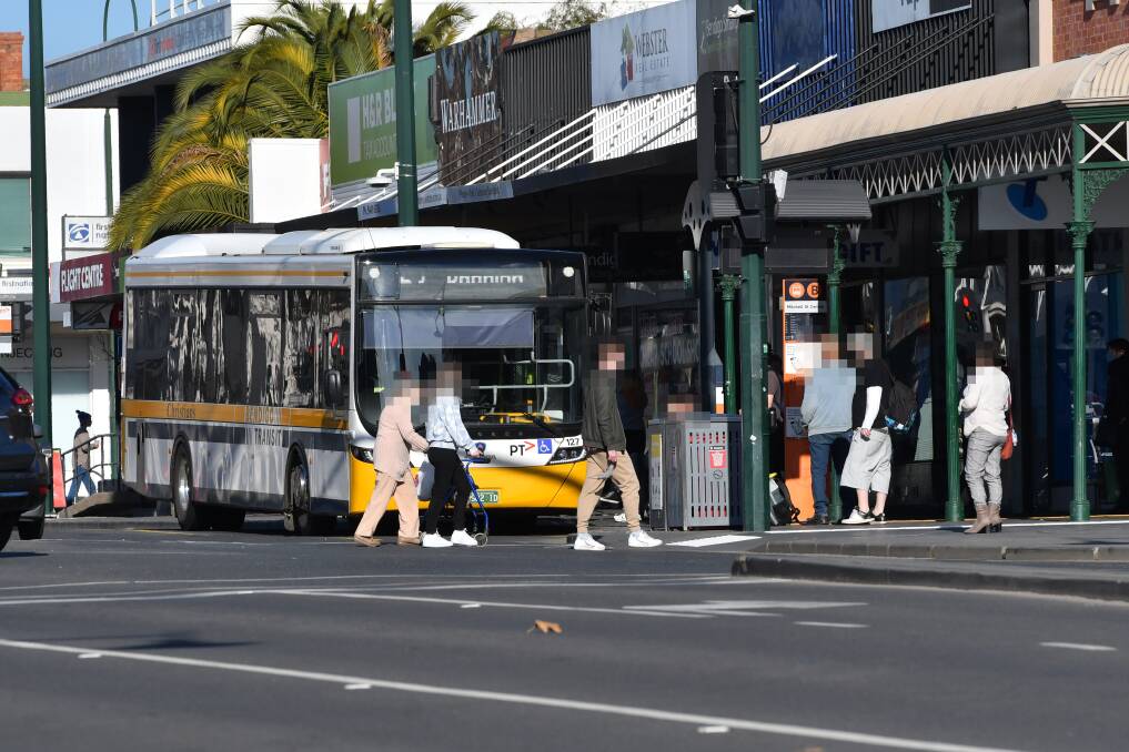 SHOP KEEPER CONDERNS: Landlords and traders say there are ongoing issues with the number of people waiting for buses on footpaths in Mitchell Street. Picture: NONI HYETT