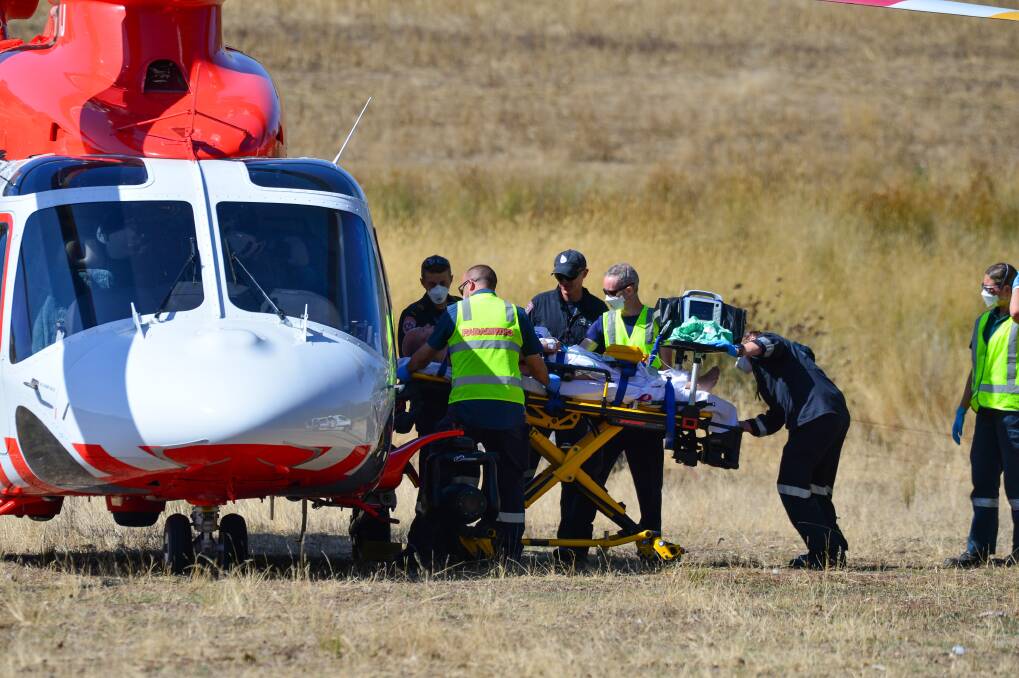 Paramedics load a 31-year-old man onto an air ambulance ready to fly to Melbourne. Picture: DARREN HOWE