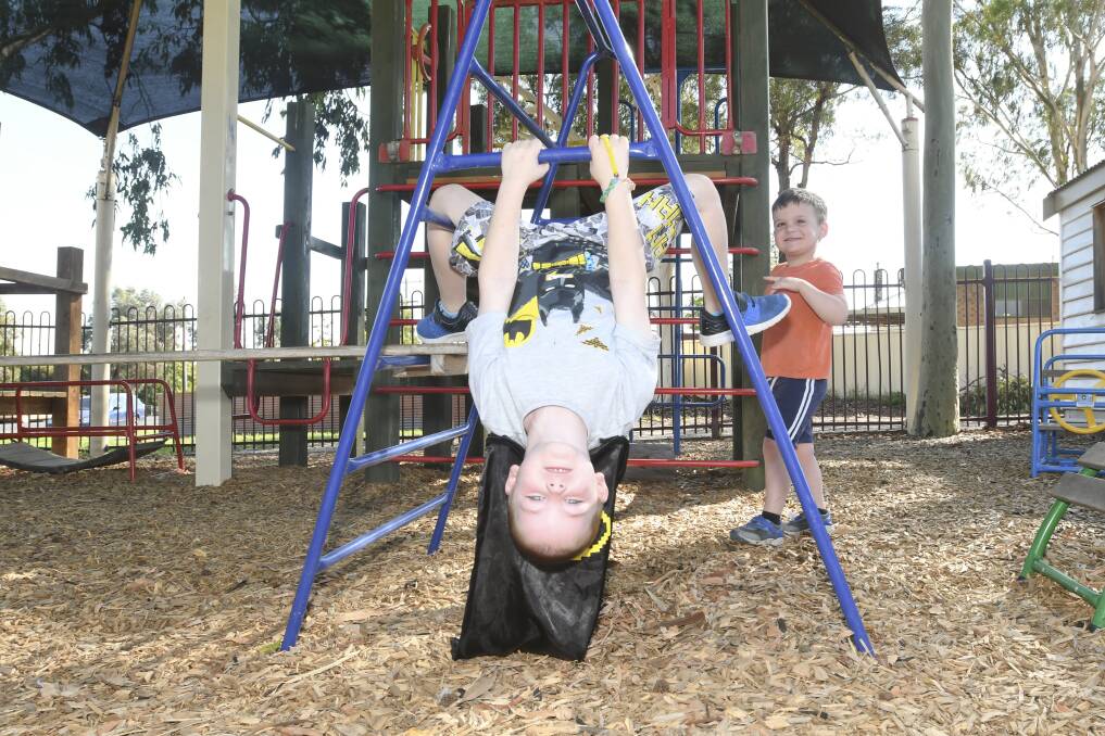 UPGRADE COMING: Cooper Norris is hanging upside down for a new playground. He will only have to wait until the end of the year. Picture: NONI HYETT