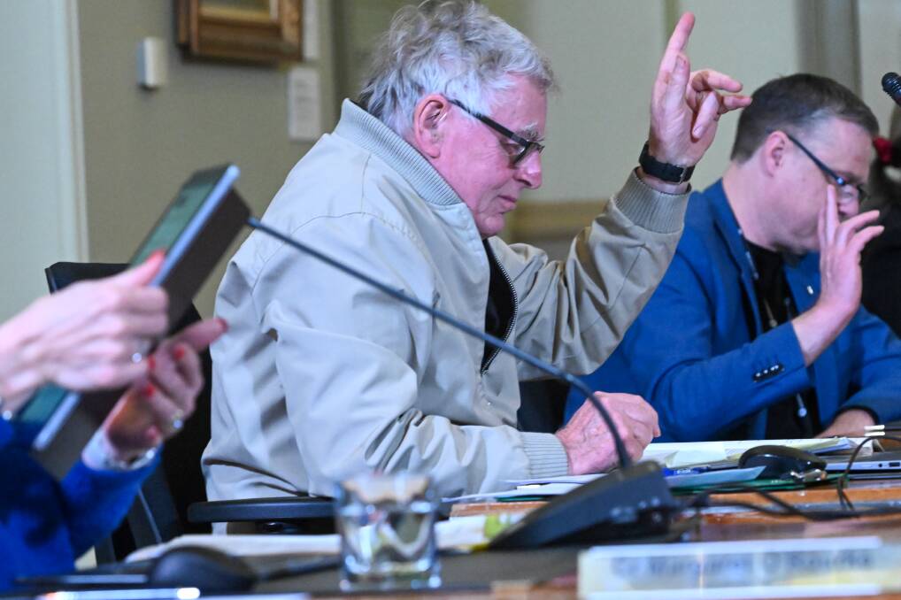 Greg Penna voting at a council meeting. Picture by Darren Howe