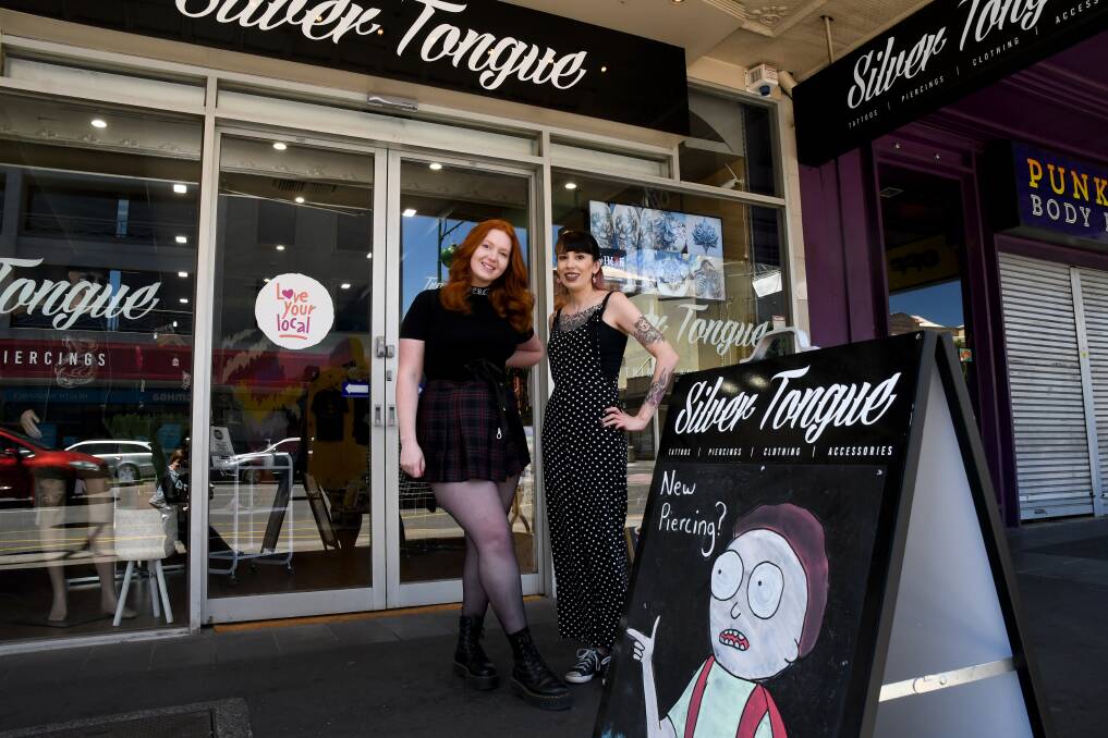 BACK TO BUSINESSES: Silver Tongue Bendigo employee April Featonby and co-owner Ash Farrow out the front of the store on Monday. Picture: NONI HYETT