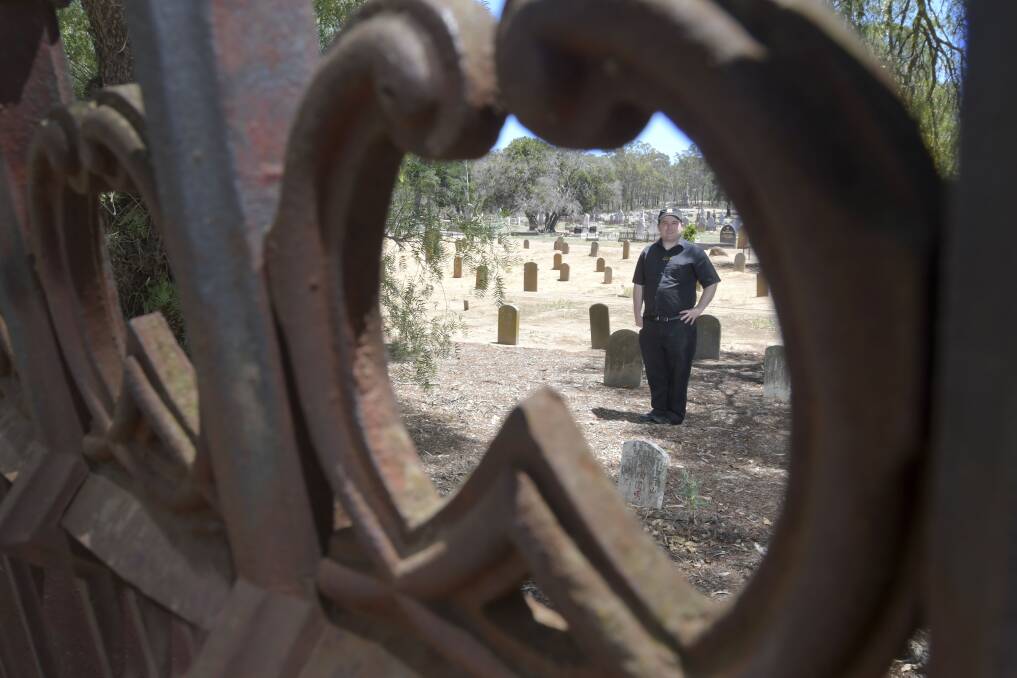 Historian Leigh McKinnon among tombstones in White Hills, Bendigo. Picture: NONI HYETT