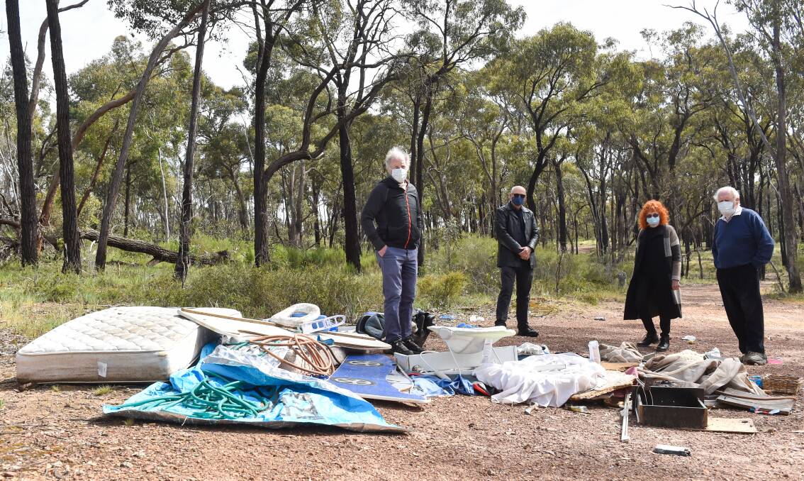 TIME TO CLEAN UP: Colin O'Brien, Colin Lambie, Sally van Gent and Bob Stonehouse next to a pile of rubbish typifying many around greater Bendigo. Picture: DARREN HOWE