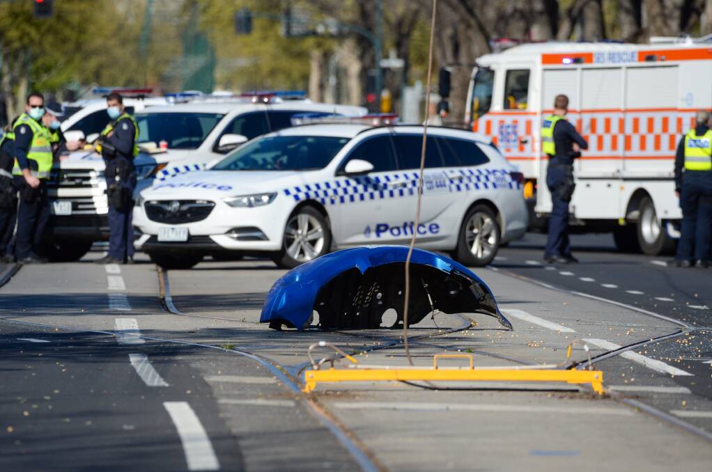 Emergency service workers and volunteers survey the scene of a fatal car crash. Picture: DARREN HOWE