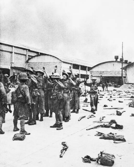 British soldiers surrender to the advancing Japanese army after the unconditional surrender. Picture: Courtesy of the AUSTRALIAN WAR MEMORIAL