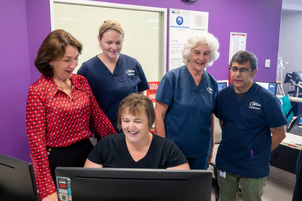 Chief executive Eileen Hannagan with members of her Bendigo Health team working in a hospital discharge unit. Picture by Enzo Tomasiello