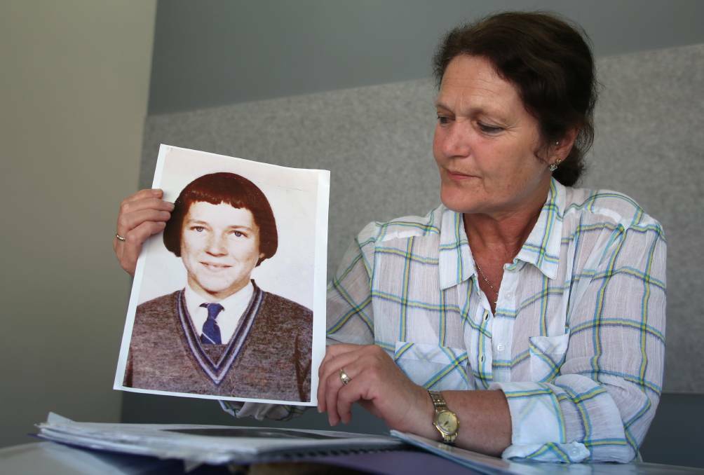 Lyn holds an image of her sister Maureen Braddy. Lyn was 8 years old when Maureen went missing. Picture: GLENN DANIELS