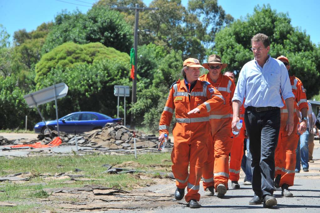 DESTRUCTION: Then-premier Ted Baillieu inspects Carisbrook in the aftermath of 2011 flooding, along with SES Maryborough controller Jesse Wright. Picture: BRENDAN McCARTHY