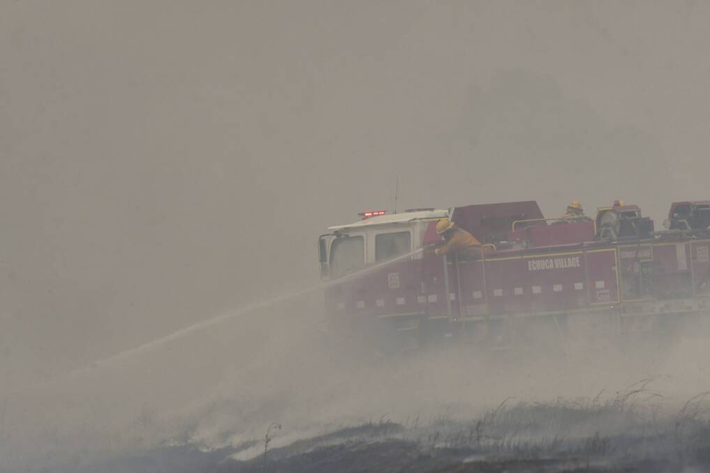 Firefighters battle the blaze near Rochester. Picture: NONI HYETT
