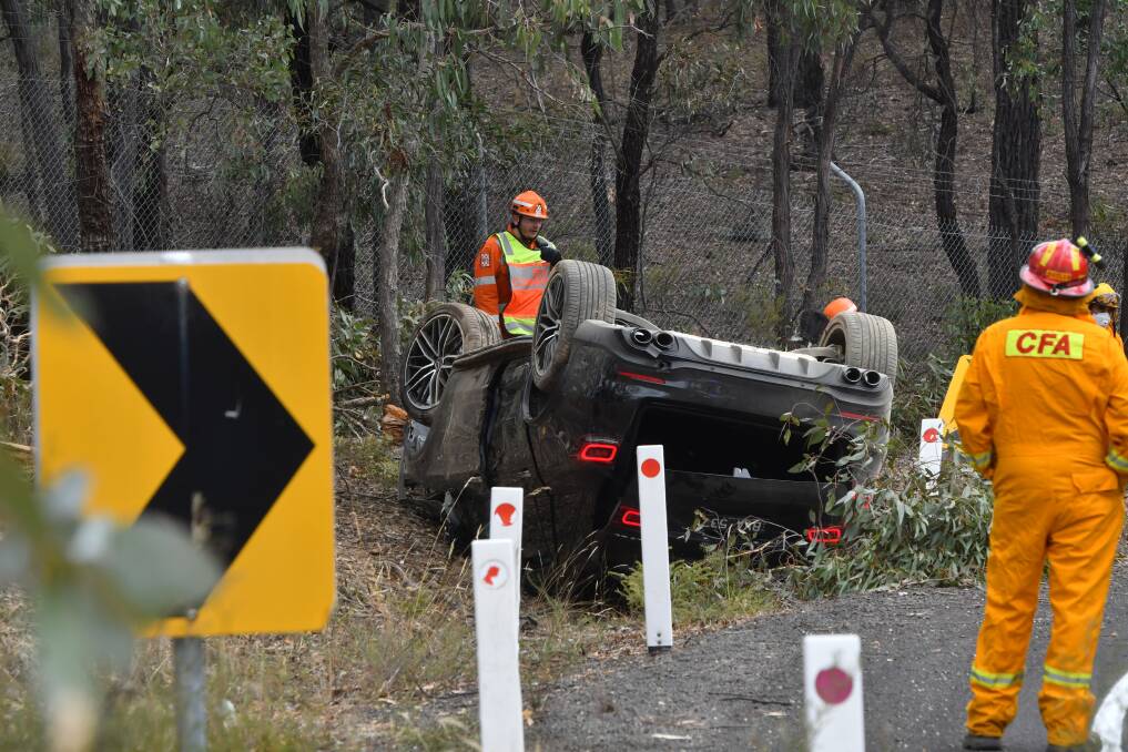 A black car flipped onto its roof in a crash near Kangaroo Flat on Friday. Picture: NONI HYETT