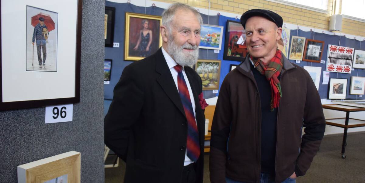 COLORFUL CONVERSATION: Local artists Neil Gude and Chris Moule catch up ahead of the annual Winter Art Show at the Kangaroo Flat Uniting Church. Picture: TOM O'CALLAGHAN