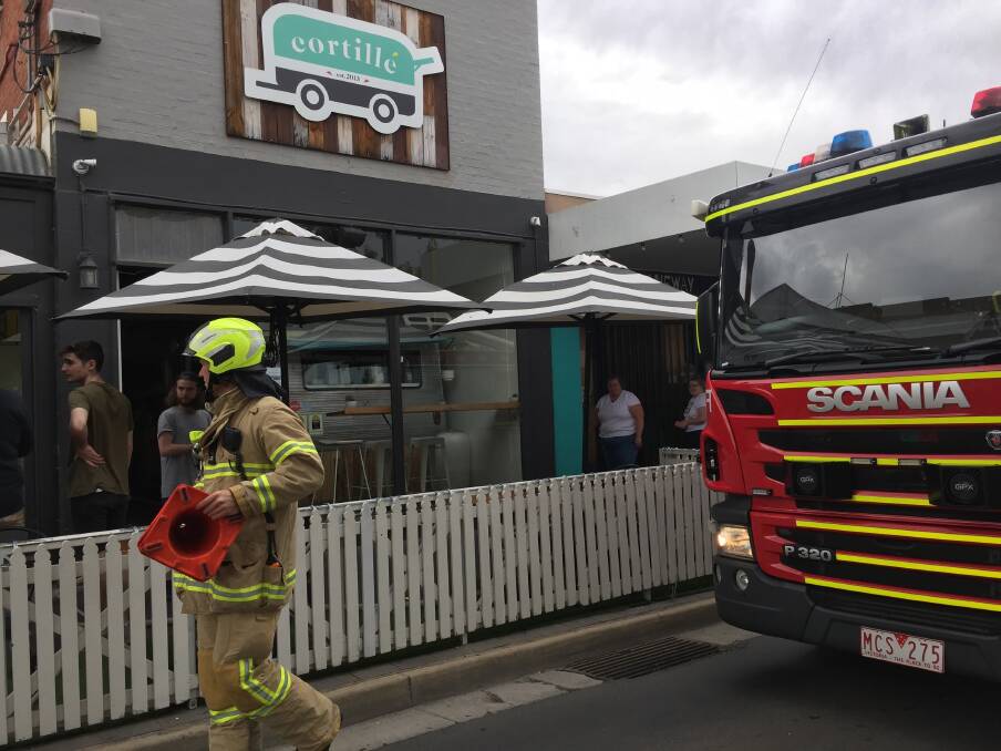 A firefighter helps block a section of Lyttleton Terrace after a small fire out the back of a restaurant. Picture: TOM O'CALLAGHAN
