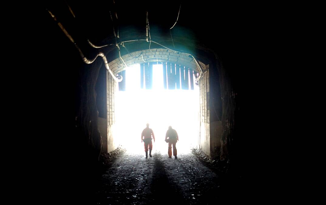 Workers at the entrance to a mine.