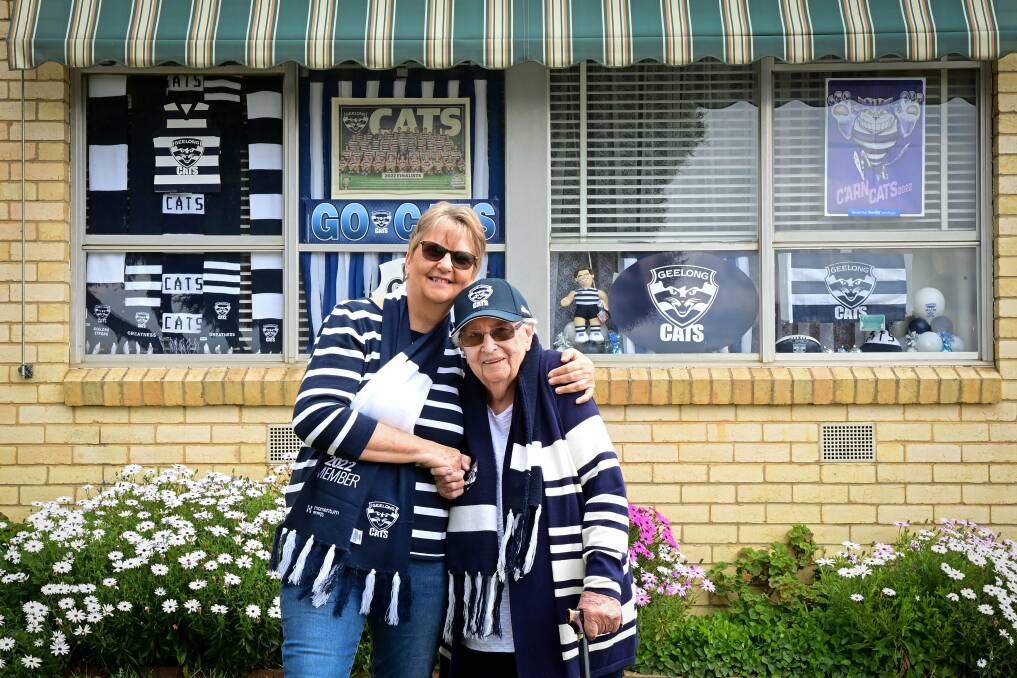 Lyn Roulston and her mother Carmel Bath outside a North Bendigo shrine to the Geelong Cats. Carmel's brother Peter Pianto played for and coached the team in the 1950s and '60s. Picture by Brendan McCarthy