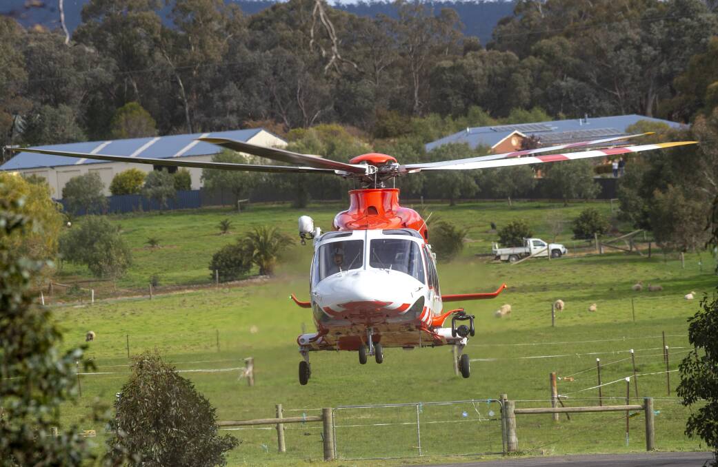 An air ambulance arrives at the scene of a serious car crash in Mandurang on Sunday morning. Picture: DARREN HOWE