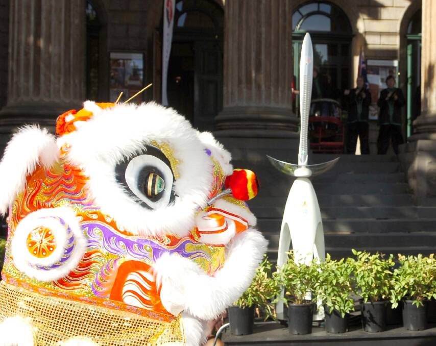 A Chinese lion joins festivities during the Queen's baton relay ahead of the 2006 Melbourne Commonwealth Games. Picture by Bill Conroy.