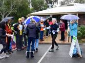 Volunteers hand out how to vote cards at Kangaroo Flat on Monday. Picture: BRENDAN McCARTHY