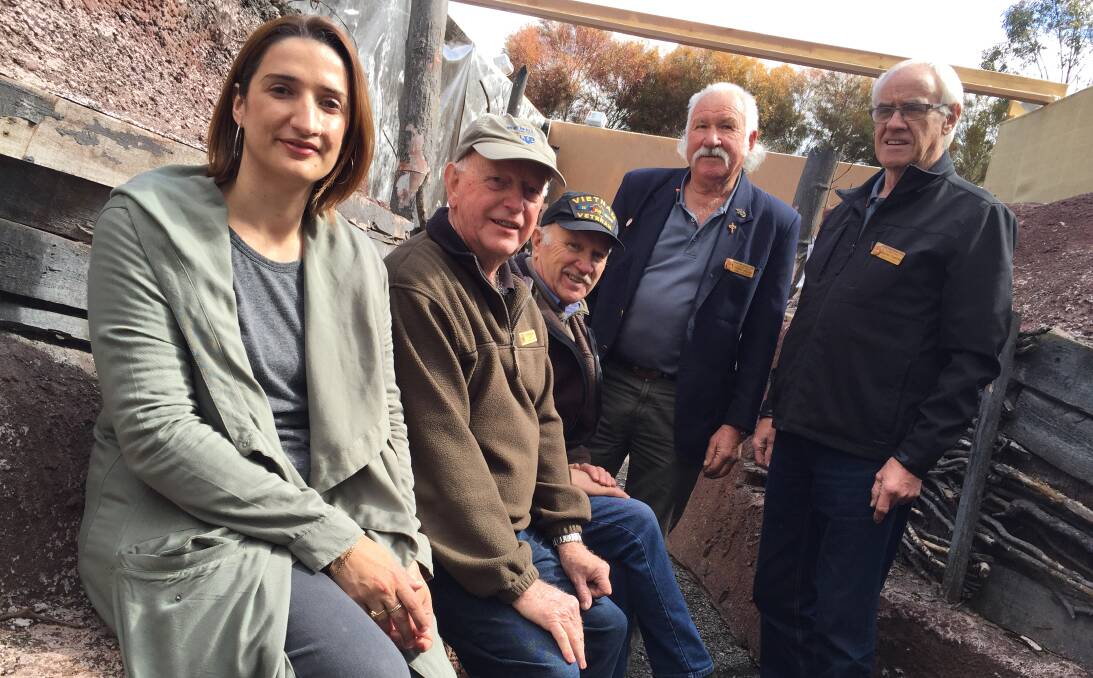 IN THE TRENCHES: Teacher Trish Di Donato joins veterans Cliff Richards, Bill Clarke, Terry Nolan and Graham Flanders in a simulation of a WW1 trench. The trench is part of an upcoming exhibition out the back of the Bendigo RSL.