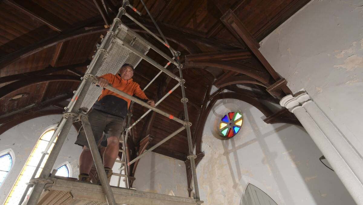 Gary Robertson pauses during his work on the interior of the Bendigo Mortuary Chapel. Picture: NONI HYETT