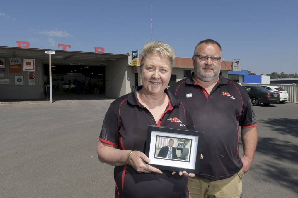 Nikki and Dean Rundle. Nikki holds a picture of her father Bob IcInnes, who passed away four years ago. Picture: NONI HYETT